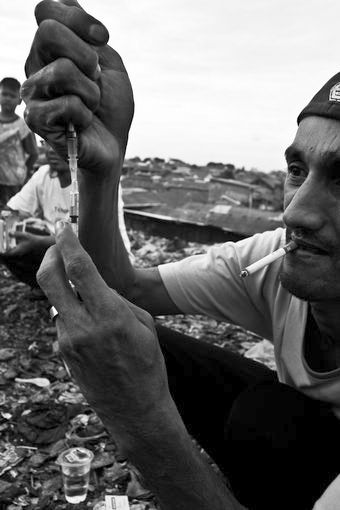 Yanto, a drug user and father of twins, prepares his dose of heroin in East Jakarta slum district of Kota Bambu Selatan perry2.jpg